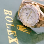 Rolex watch next to the word Rolex