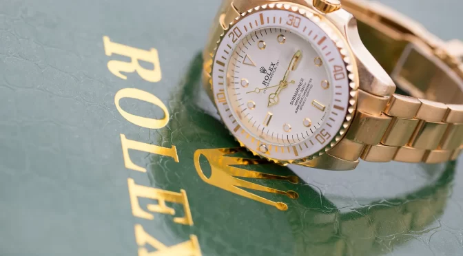 Rolex watch next to the word Rolex