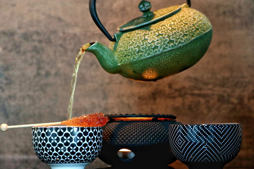 Tea pouring tea into cup