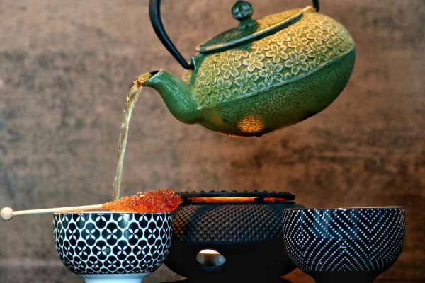 Tea pouring tea into cup