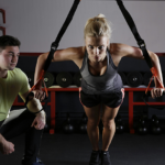 Lady working out in front of trainer